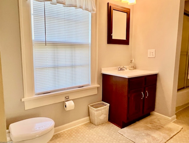 bathroom featuring vanity, toilet, and walk in shower