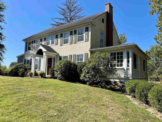 colonial home with a front lawn