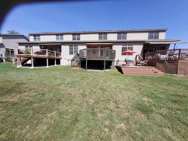 rear view of property with a lawn and a deck