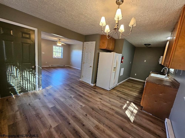 kitchen with a baseboard radiator, dark hardwood / wood-style flooring, and white refrigerator with ice dispenser