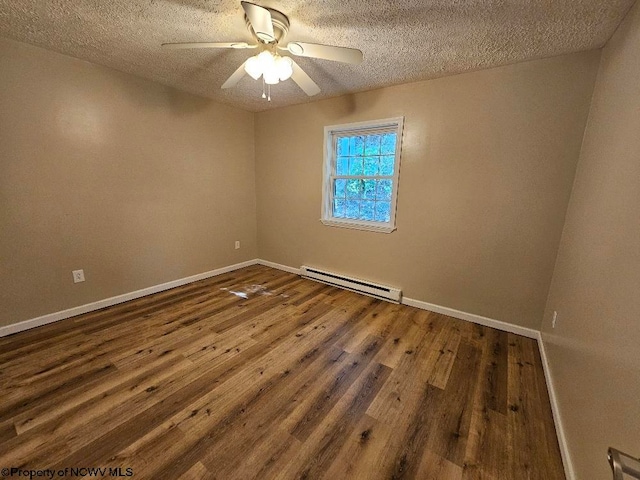 unfurnished room featuring ceiling fan, dark hardwood / wood-style floors, a baseboard heating unit, and a textured ceiling