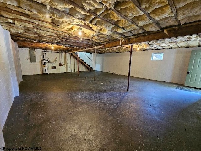 basement featuring electric panel and water heater