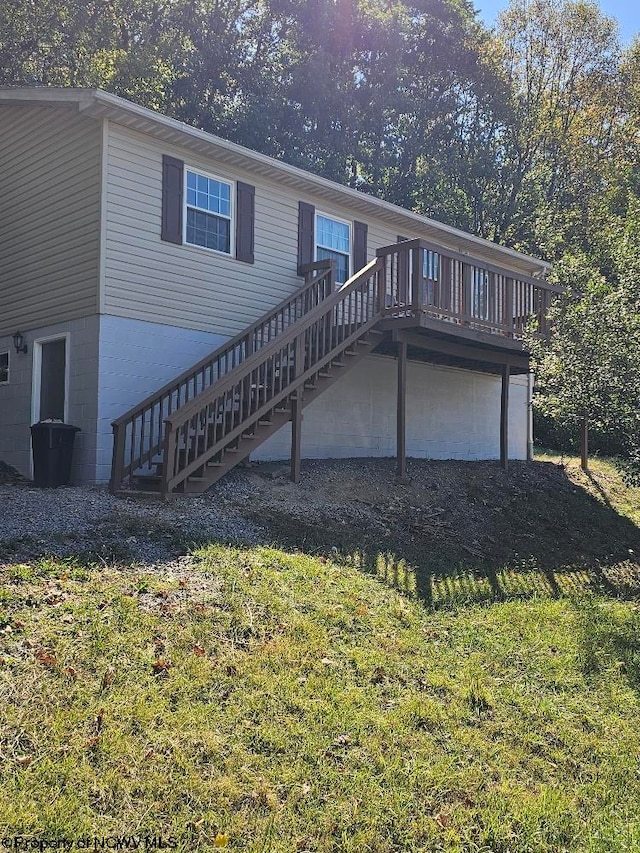 back of house with a yard and a wooden deck