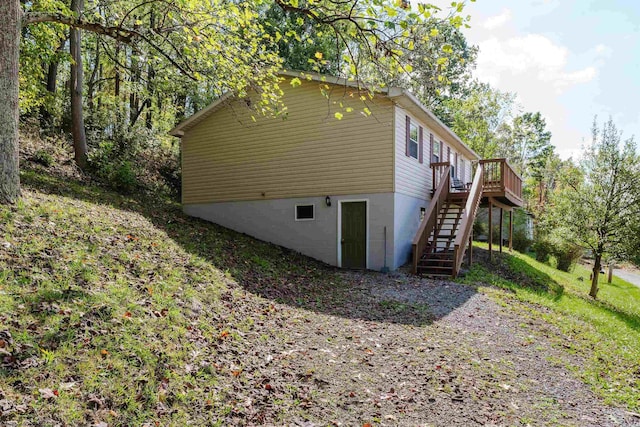 view of side of home featuring a wooden deck