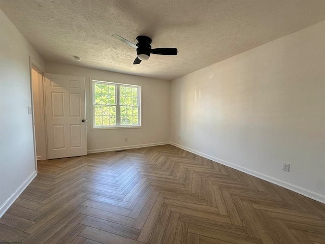 spare room featuring ceiling fan and a textured ceiling