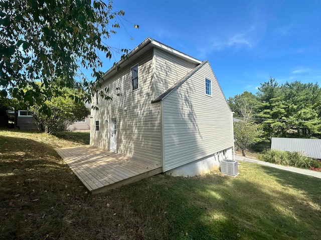 exterior space featuring central AC unit and a yard