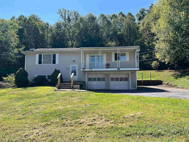 bi-level home featuring a garage and a front lawn