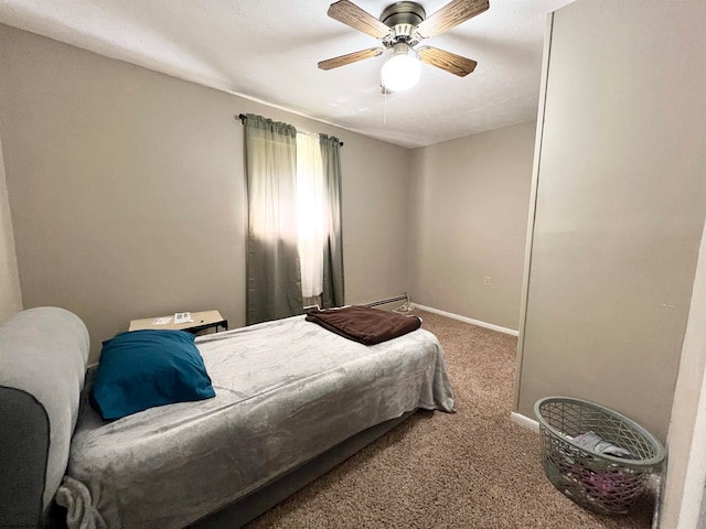 bedroom with baseboard heating, carpet, and ceiling fan