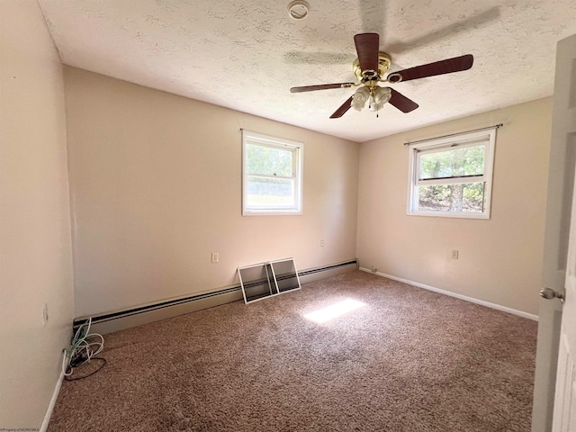 carpeted spare room featuring a textured ceiling, a healthy amount of sunlight, ceiling fan, and a baseboard radiator