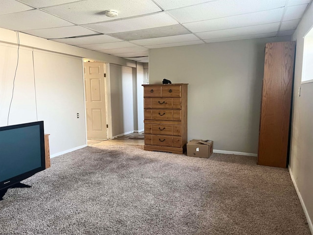 carpeted spare room featuring a paneled ceiling