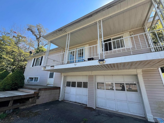 view of side of property with a garage and a balcony