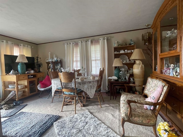 dining space with carpet and ornamental molding