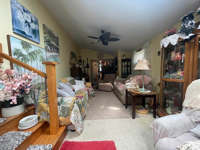 carpeted living room with ceiling fan and vaulted ceiling