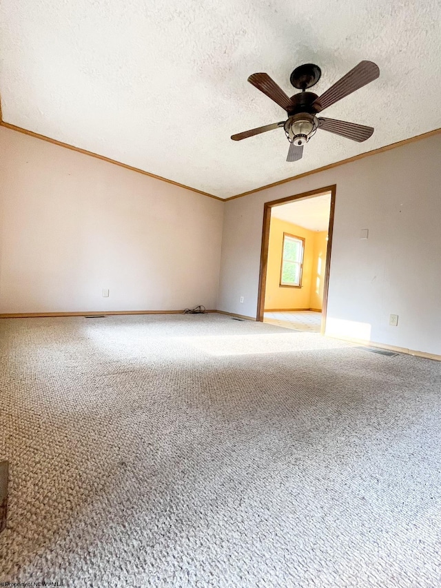 unfurnished room featuring crown molding, a textured ceiling, ceiling fan, and carpet flooring