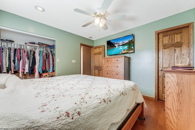 bedroom with ceiling fan, a closet, and wood-type flooring