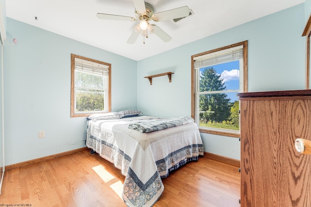 bedroom with light hardwood / wood-style flooring and ceiling fan