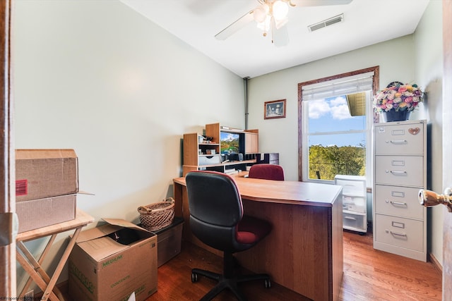 home office with light wood-type flooring and ceiling fan