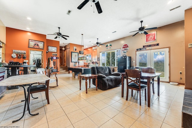 living room featuring ceiling fan, light tile patterned floors, and french doors