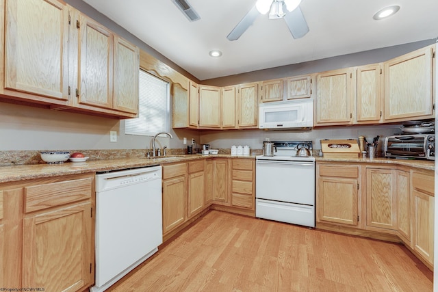 kitchen featuring white appliances, light hardwood / wood-style flooring, sink, light brown cabinets, and ceiling fan