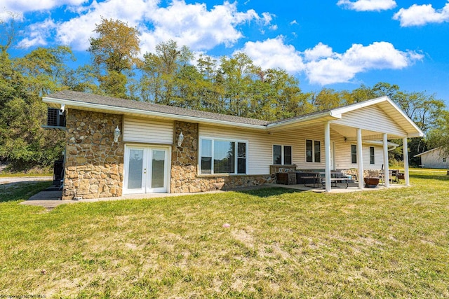 rear view of house featuring a lawn and a patio area