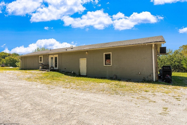 view of side of home with central air condition unit