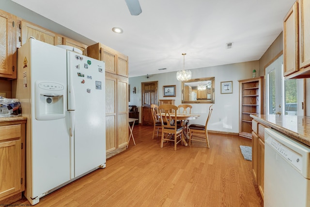 kitchen with white appliances, pendant lighting, light brown cabinetry, light hardwood / wood-style floors, and light stone counters