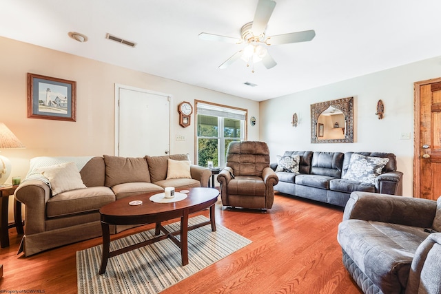 living room with ceiling fan and wood-type flooring