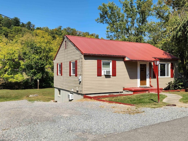 view of front of house featuring a front yard and cooling unit