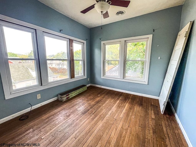 spare room featuring ceiling fan and dark hardwood / wood-style flooring