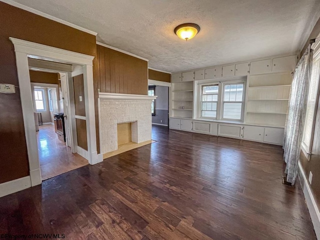 unfurnished living room featuring built in features, a textured ceiling, a fireplace, and dark hardwood / wood-style flooring