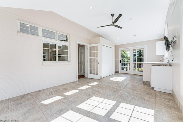 interior space featuring a ceiling fan, recessed lighting, french doors, baseboards, and vaulted ceiling