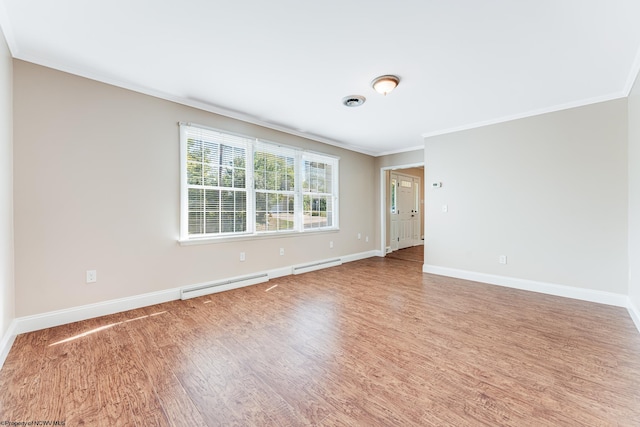 empty room with ornamental molding, baseboard heating, and hardwood / wood-style floors