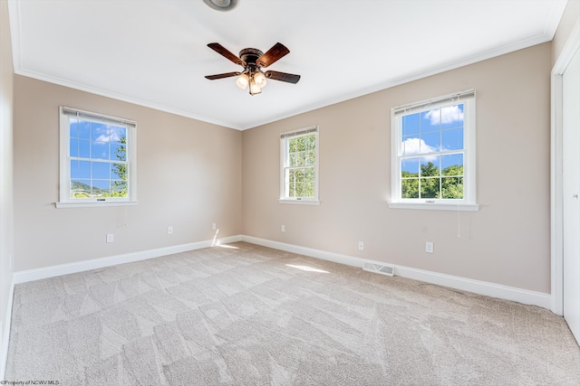 unfurnished room with visible vents, ornamental molding, carpet floors, baseboards, and ceiling fan