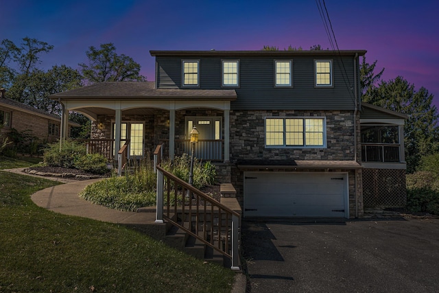 view of property featuring a porch and a garage