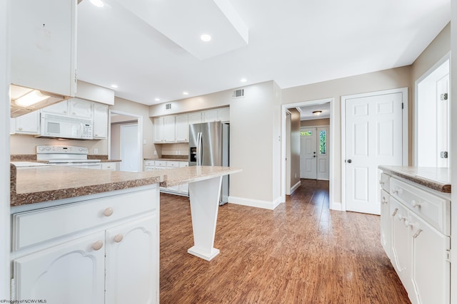 kitchen featuring light wood-type flooring, white appliances, and white cabinetry