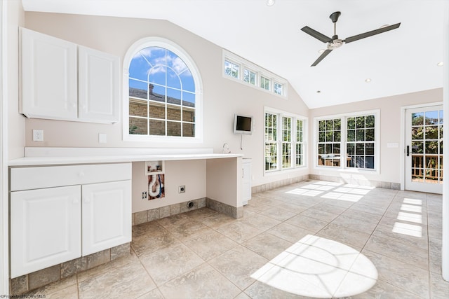 interior space with high vaulted ceiling, ceiling fan, and tile patterned floors