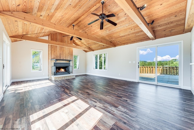 unfurnished living room featuring ceiling fan, a fireplace, lofted ceiling with beams, and dark hardwood / wood-style flooring