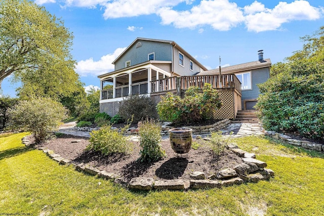 back of house featuring a lawn, a deck, stairway, a sunroom, and a chimney