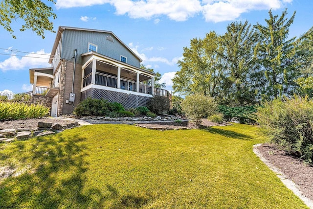 back of house with a lawn