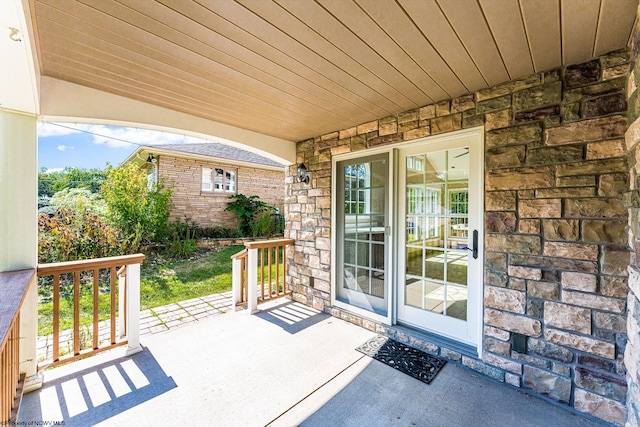 view of exterior entry with covered porch