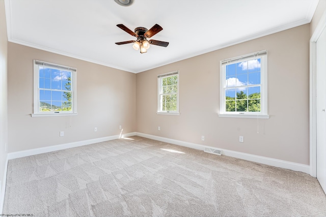 carpeted empty room featuring ornamental molding and ceiling fan