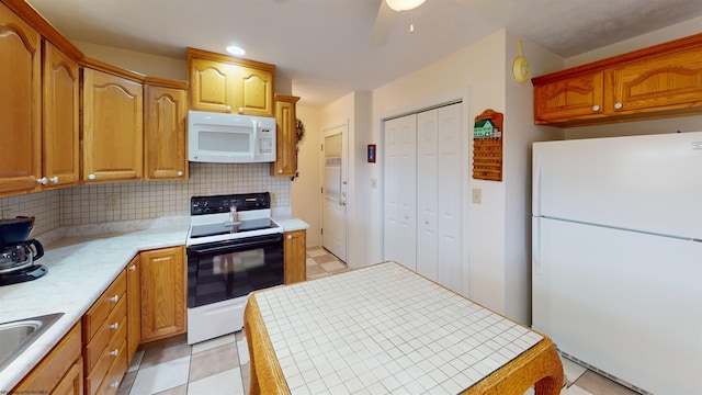 kitchen featuring ceiling fan, light tile patterned floors, white appliances, tile counters, and decorative backsplash