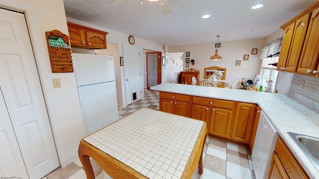 kitchen featuring pendant lighting, decorative backsplash, white appliances, light tile patterned floors, and ceiling fan