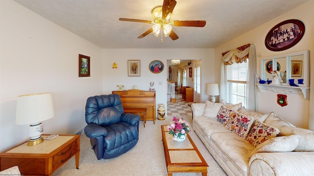 carpeted living room with ceiling fan