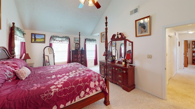 carpeted bedroom with ceiling fan and vaulted ceiling