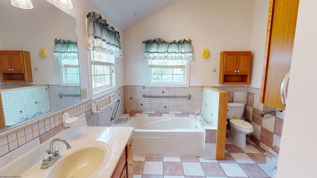 bathroom with vanity, lofted ceiling, a bathtub, tile walls, and toilet