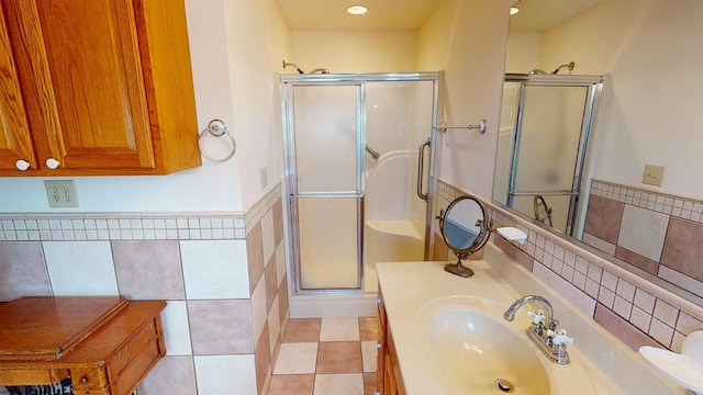 bathroom featuring vanity, tile patterned flooring, and a shower with door