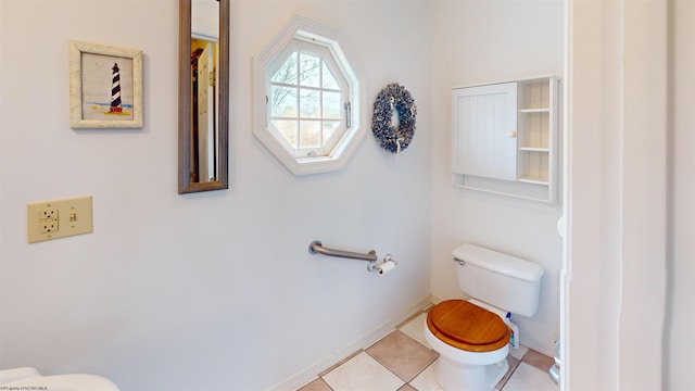 bathroom featuring toilet and tile patterned floors