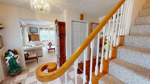 stairs featuring a textured ceiling and tile patterned flooring