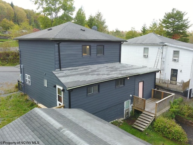 rear view of property featuring a wooden deck